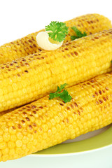 Delicious golden grilled corn with butter close-up