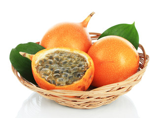 Passion fruits in wicker basket isolated on white