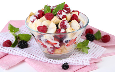 Fruit salad in glass bowl, isolated on white