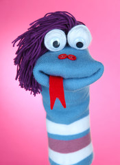 Cute sock puppet on pink background