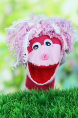 Cute sock puppet on bright background