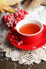 Obraz na płótnie Canvas Still life with viburnum tea in cup, berries and snow,