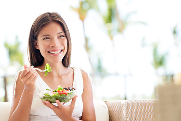 Healthy lifestyle woman eating salad smiling happy - Powered by Adobe