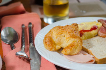 Breakfast with Toast and croissants on table..