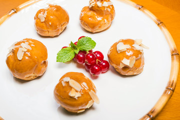 Profiteroles with vanilla cream topped with caramel sauce