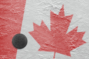 Canadian flag and the puck on the ice