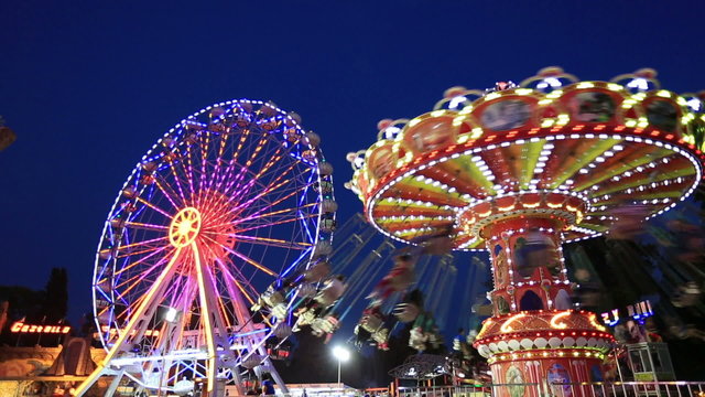 Swing and Ferris Wheel at amusement park