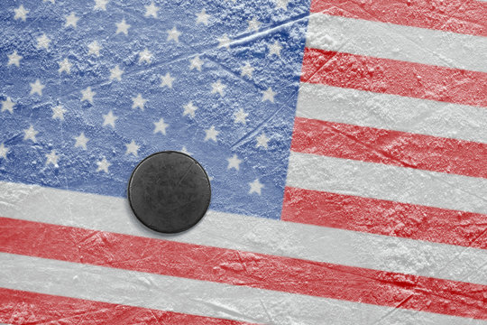 The American flag and the puck on the ice
