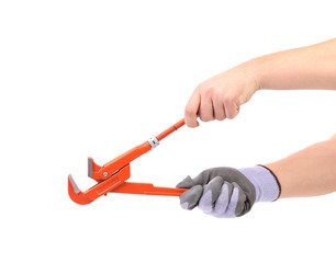 Hand in gloves holding wrench.