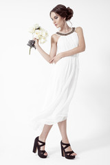 Young brunette woman and white roses. White Background.
