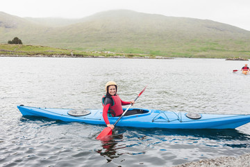 Fototapeta premium Smiling woman in a kayak