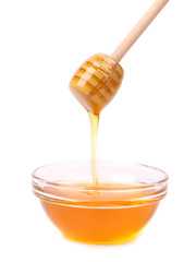 Bee honey with wooden dipper.