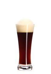 Glass of brown beer with foam.