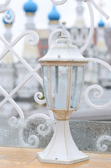 White outdoor lantern under the rain