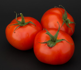 Tomato vegetables isolated on black background