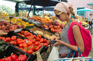 girl buying fruits at green market
