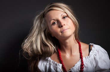 Folk woman in folklore clothes braiding a plait