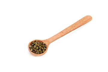 green pepper in wooden spoon