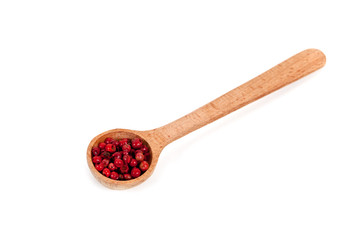 pink pepper in a wooden spoon