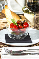tomatoes and cheese in a glass bowl