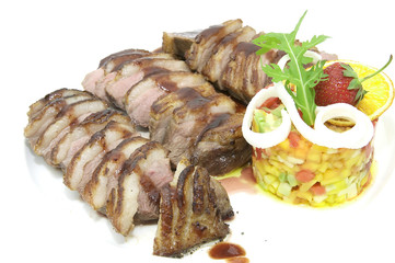 plate of meat and grilled vegetables on a white background