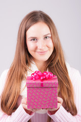 Beautiful woman holding gift