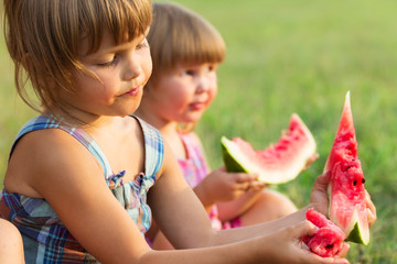 Girls eat sweet and tasty water-melon