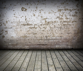 Room with damaged brick wall