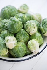 Fototapeta premium Brussels sprouts covered with water drops, vertical shot