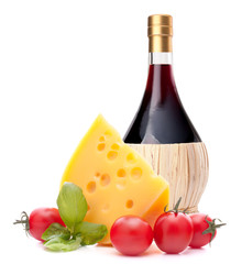 Red wine bottle, cheese and tomato still life