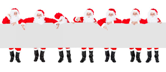 Group Of Santa Claus With Poster Banner