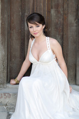 Naklejka premium Portrait of a beautiful girl in white. Gentle and elegant style.