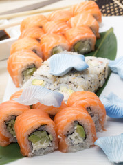 Philadelphia and california sushi roll on white plate