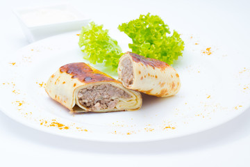 Pancake with meat with salad on white dish