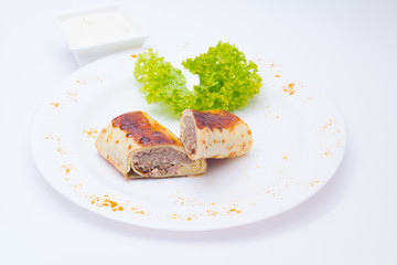 Pancake with meat with salad on white dish