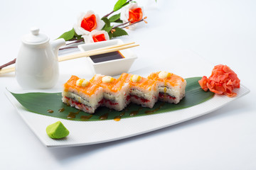 Oshi sushi on white plate with wasabi and decorated with sakura