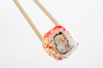 Single sushi roll in tempura and chopsticks