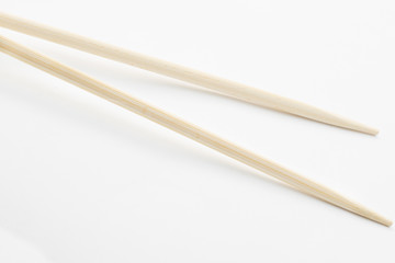 Bamboo chopsticks on white background
