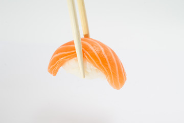 Salmon sushi nigiri with chopsticks