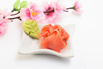 Ginger and wasabi on white plate with sakura