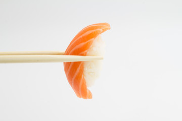 Salmon sushi nigiri with chopsticks