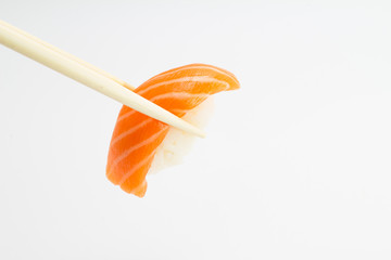 Salmon sushi nigiri with chopsticks