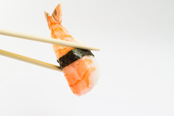 Shrimp sushi nigiri with nori in chopstick on white background