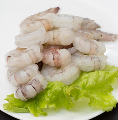 Raw shrimp on plate with salad and soy sauce