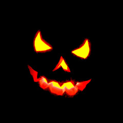 Fototapeta premium Glowing Halloween pumpkin isolated on black.