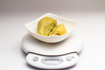 Stuffed peppers in white dish on balance