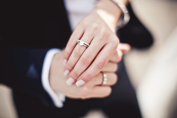 Holding hands with wedding rings