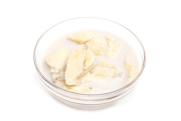 banana in coconut milk in glass bowl  - Thai dessert