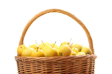 yellow apples in a wicker basket