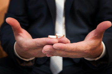 Gold wedding rings on a hand of the groom